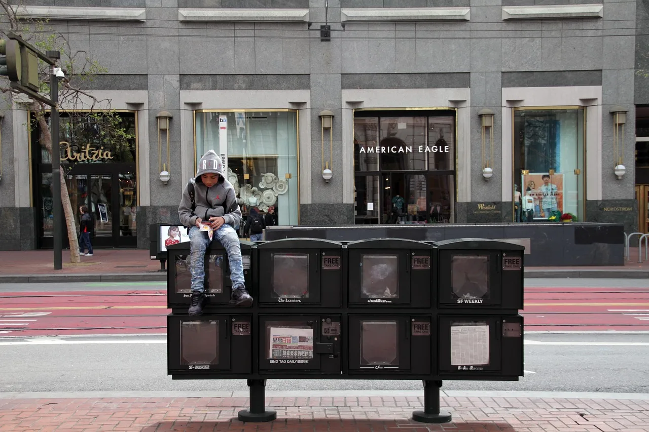 boy, reading, newspaper, kiosk, san francisco, kids, gray reading, gray newspaper. What does a local newspaper ad actually cost?