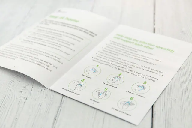 white printer paper on brown wooden table Coronavirus Stay at home. Save the NHS, protect lives. Leaflet from the government with advice. Coronavirus, stay indoors, stay at home, d. Marketing collateral: a focused business guide for 2027