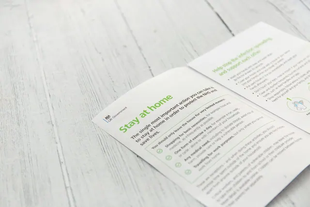 white printer paper on gray wooden table Coronavirus Stay at home. Save the NHS, protect lives. Leaflet from the government with advice. Coronavirus, stay indoors, stay at home, do. Print advertising: a practical guide for 2027