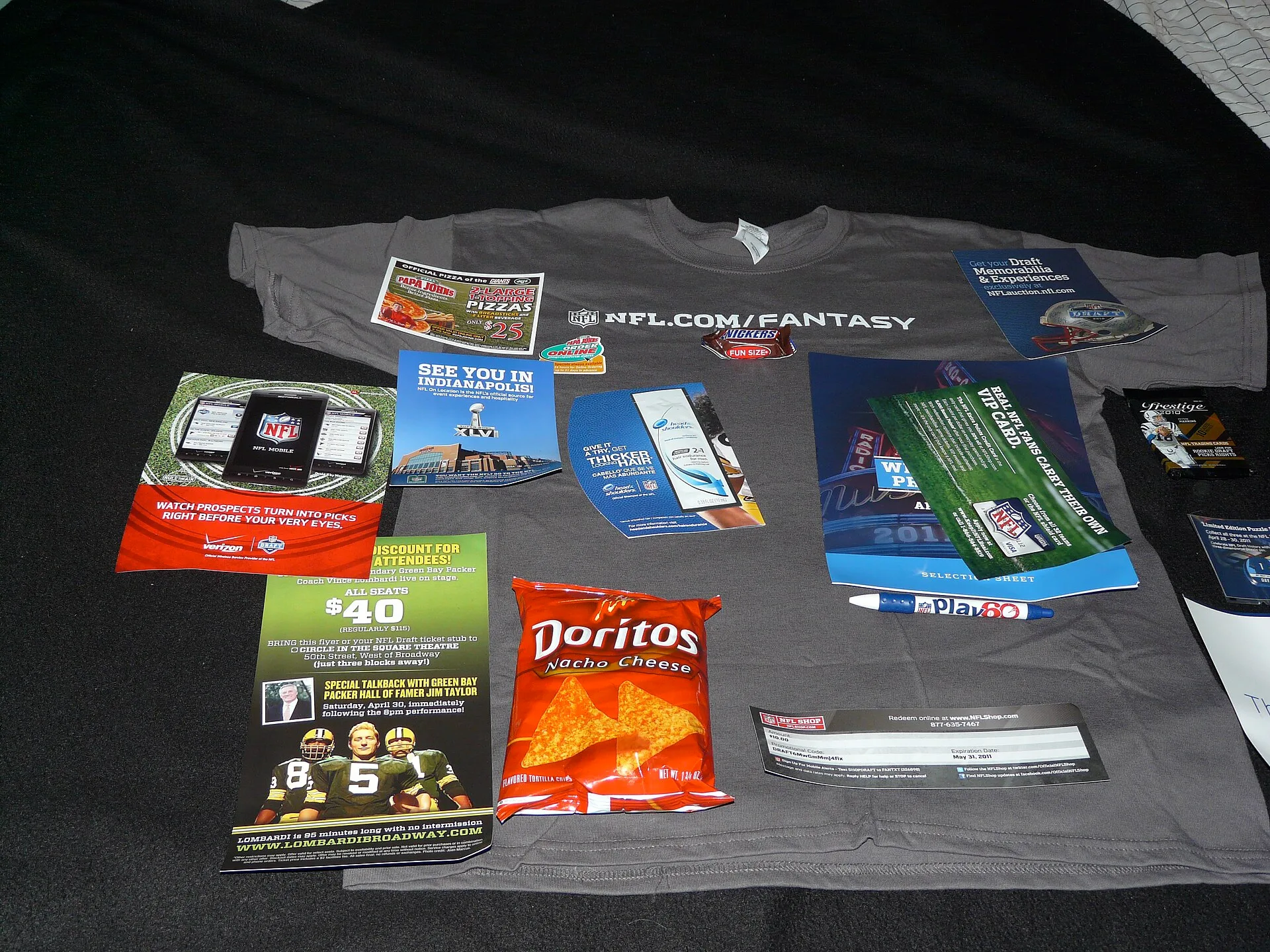 From a tee-shirt to a Snickers bar, a Play 60 pen, a bag of Doritos, assorted coupons for play tickets ("Lombardi"), Verizon phones, Papa John's Pizza (and a magnet!), football cards, draft guide. Reviewing promotional product marketing: strengths, gaps and a verdict